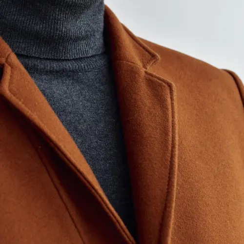 Custom Blazers & Sport Coats 2 Close-up of a rust-colored sport coat with peak lapel over charcoal turtleneck
